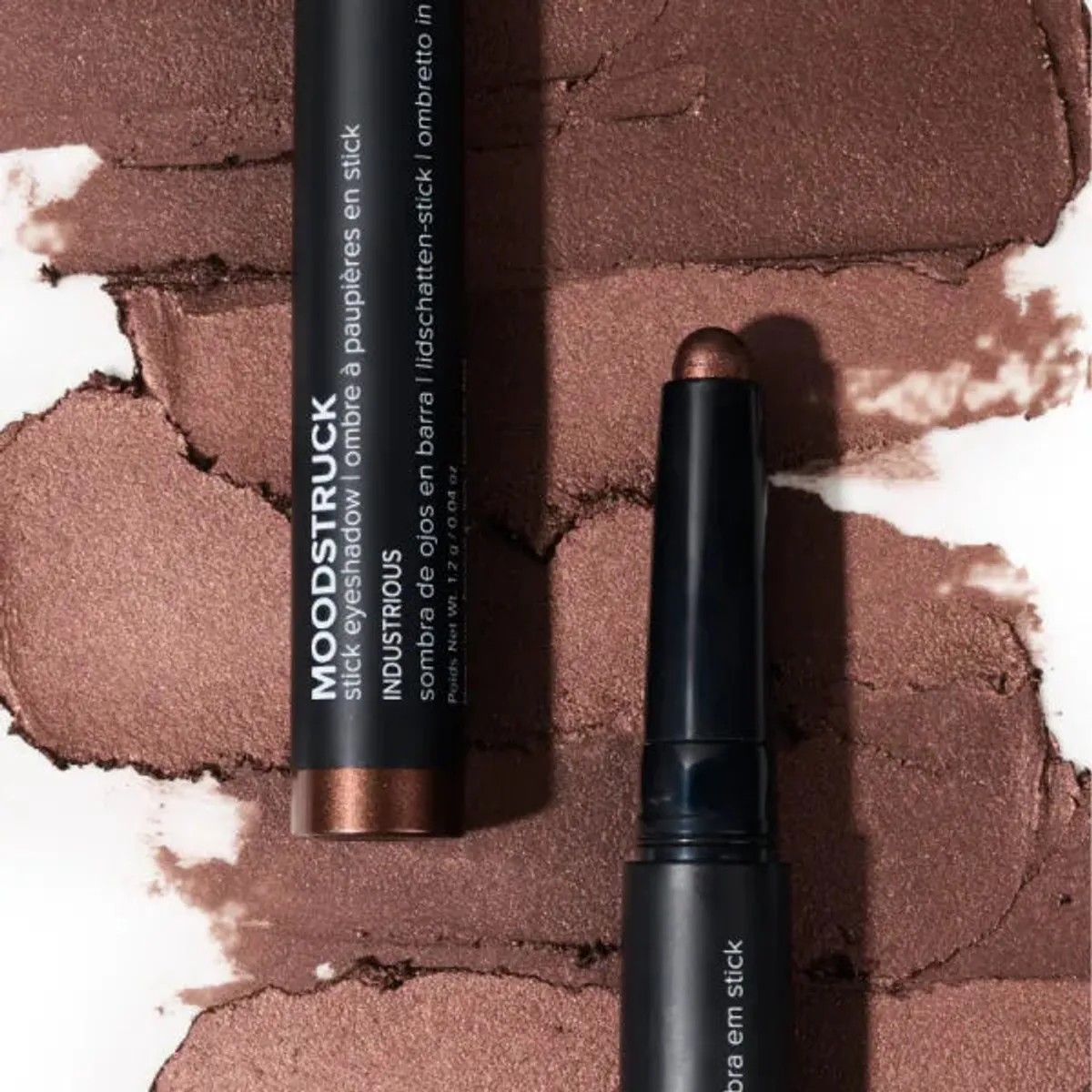 Younique MOODSTRUCK eyeshadow stick in Industrious, a shimmer rosy chocolate brown shade: stick and colour swatch