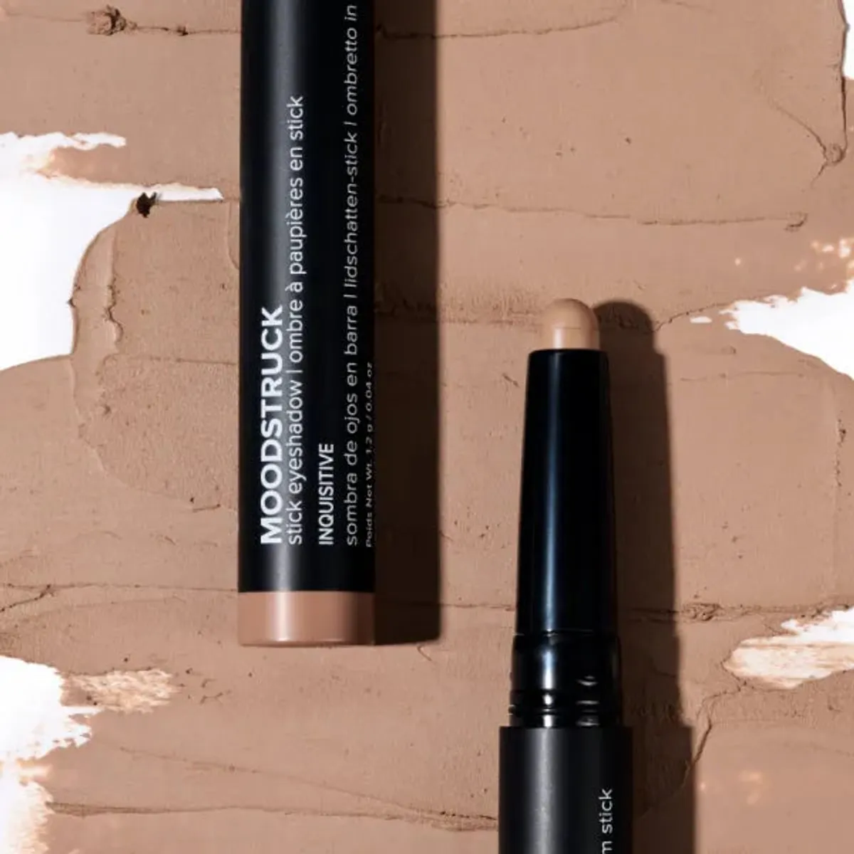 Younique MOODSTRUCK eyeshadow stick in Inquisitive, a matte sandy beige shade: stick and colour swatch