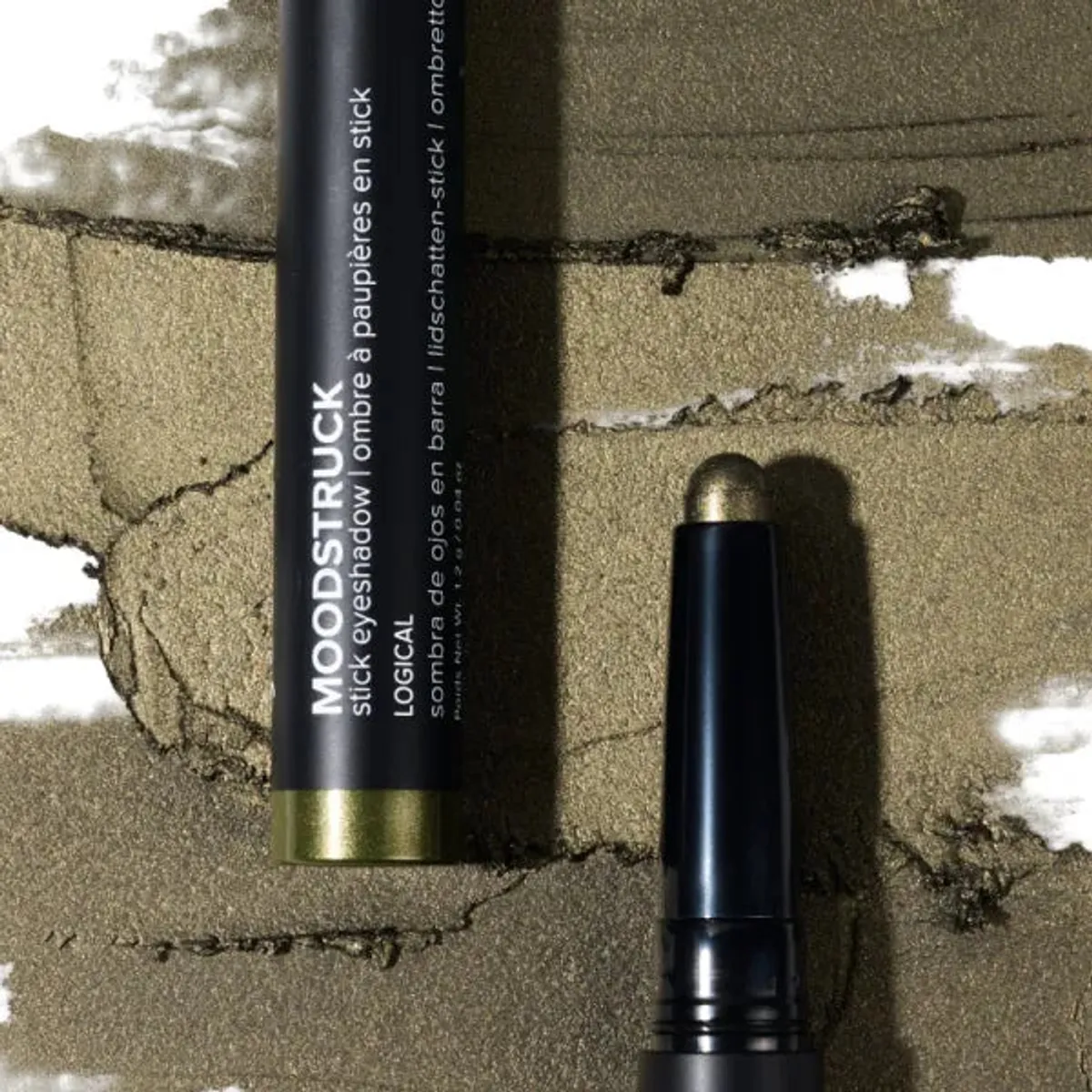 Younique MOODSTRUCK eyeshadow stick in Logical, a shimmer olive green shade: stick and colour swatch