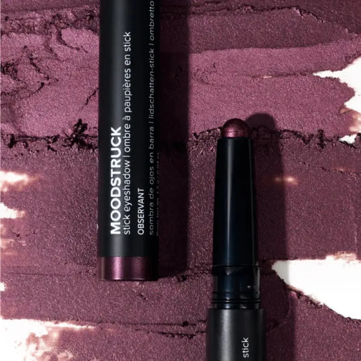 Younique MOODSTRUCK eyeshadow stick in Observant, a shimmer aubergine plum shade: stick and colour swatch