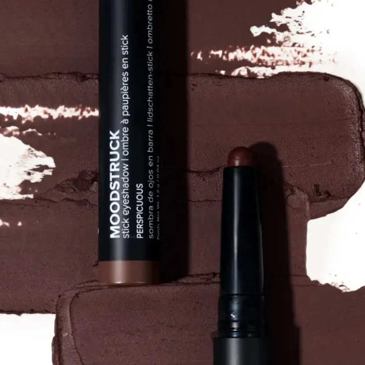 Younique MOODSTRUCK eyeshadow stick in Perspicuous, a matte dark chocolate brown shade: stick and colour swatch